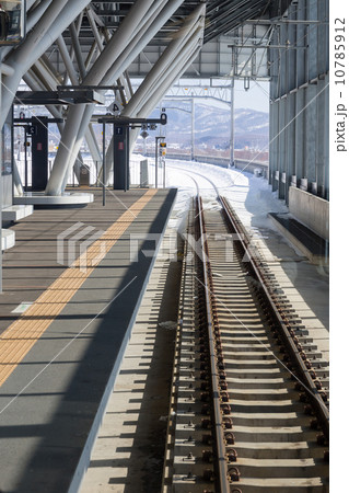 Modern Train Station Platform with Railway Tracks in Winter Modern Train Station Platform with Railway Tracks in Winter 10785912