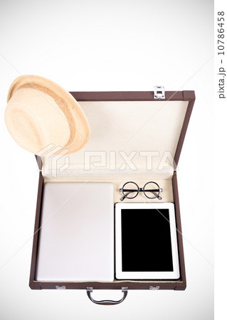 blank tablet, laptop glasses and hat in briefcase on white (filt 10786458