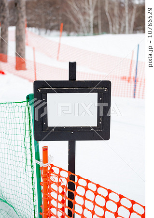 signpost in the snow in front of snow track 10786529