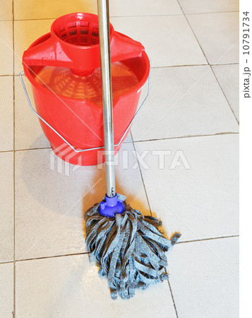 red bucket with foamy water and mopping the floor 10791734