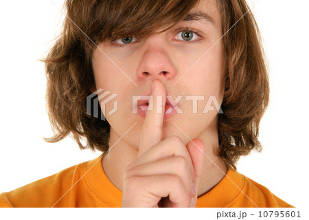 Teenager holds finger before lips 10795601