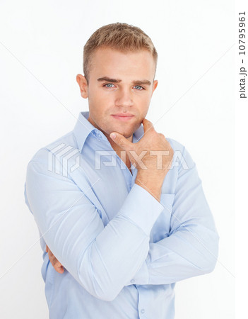 Portrait of young business man holding hand up to chin with arms 10795961