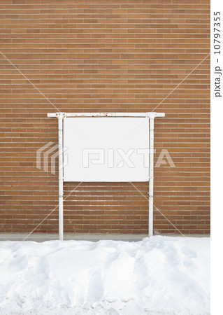 one blank billboard attached to a buildings exterior brick wall 10797355
