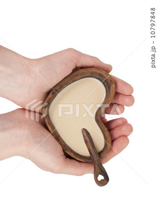 Clay cup in the form of heart with a spoon in hands Clay cup in the form of heart with a spoon in hands 10797848