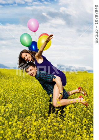 Happy couple with balloons on the yellow field Happy couple with balloons on the yellow field 10797940