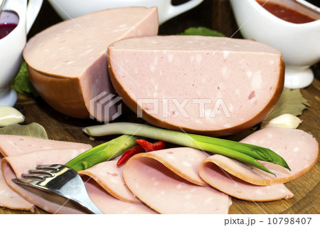 sausages on a wooden plate with vegetables in a restaurant sausages on a wooden plate with vegetables in a restaurant 10798407