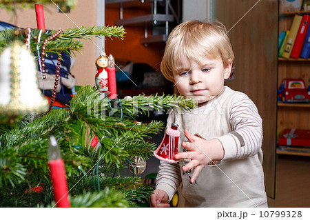 Little blond boy decorating Christmas tree at home. Little blond boy decorating Christmas tree at home. 10799328