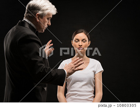 Alternative medicine therapist using hypnosis to heal his patien 10803305