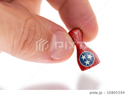 Hand holding wooden pawn, flag painting, selective focus Hand holding wooden pawn, flag painting, selective focus 10805594