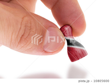 Hand holding wooden pawn, flag painting, selective focus 10805600