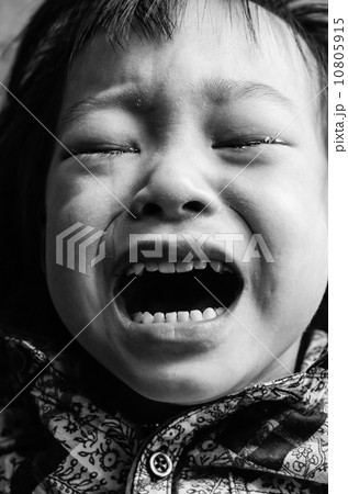 Kid crying, focus on his tear, added a bit of grain, black and w Kid crying, focus on his tear, added a bit of grain, black and w 10805915