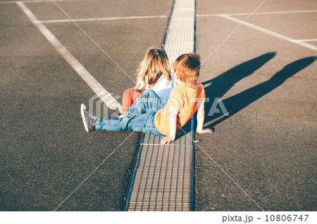 Brother helps sister running away on the road Brother helps sister running away on the road 10806747