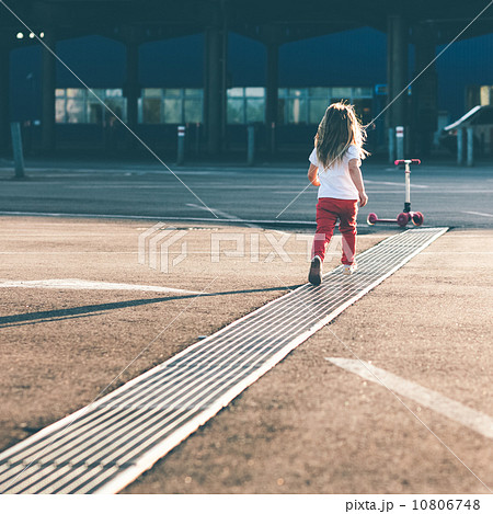 Little beautiful girl riding a scooter 10806748