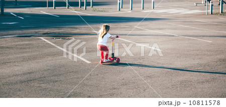 Little beautiful girl riding a scooter 10811578
