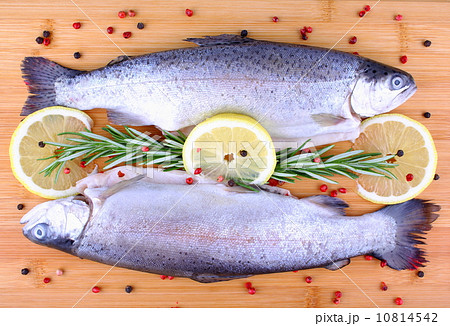 Two fresh full trout with species on bamboo board Two fresh full trout with species on bamboo board 10814542