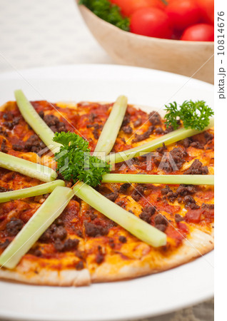 Turkish beef pizza with cucumber on top Turkish beef pizza with cucumber on top 10814676