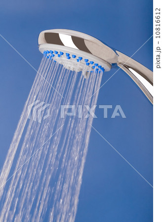Fresh cold water pours out of the shower. On a blue background. 10816612