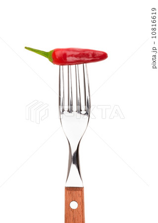 Spicy pepper paprika strung on a fork. On a white background. Spicy pepper paprika strung on a fork. On a white background. 10816619