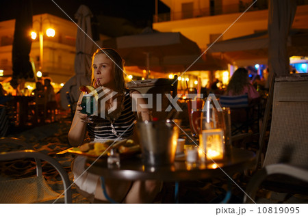 Woman enjoying a drink in a pub or restaurant Woman enjoying a drink in a pub or restaurant 10819095