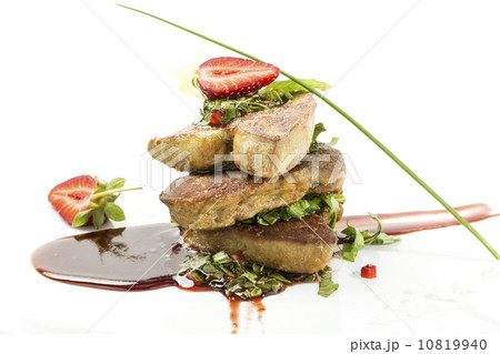 Roast goose liver is decorated with greens and strawberries Roast goose liver is decorated with greens and strawberries 10819940