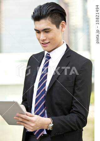 Businessman young office executive looking at tablet close up Businessman young office executive looking at tablet close up 10821494