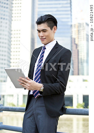Businessman young office executive looking at tablet Businessman young office executive looking at tablet 10821495