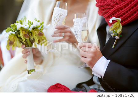 Bride and groom holding champagne glasses 10821726