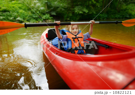 Happy little girl on a kayak on a river Happy little girl on a kayak on a river 10822121