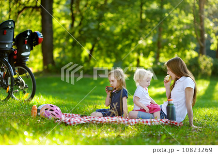Young mother and her daughters having a picnic Young mother and her daughters having a picnic 10823269