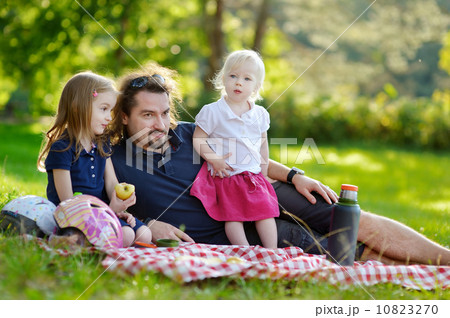 Young father and his daughters having a picnic Young father and his daughters having a picnic 10823270