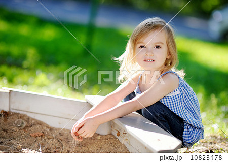 Adorable girl playing in a sandbox Adorable girl playing in a sandbox 10823478