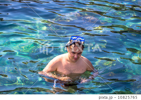 Young man snorkeling in blue sea Young man snorkeling in blue sea 10825765