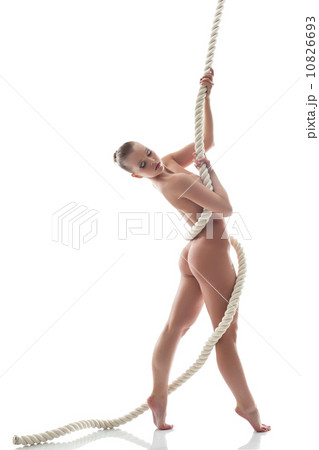 Pretty nude model posing with rope in studio 10826693