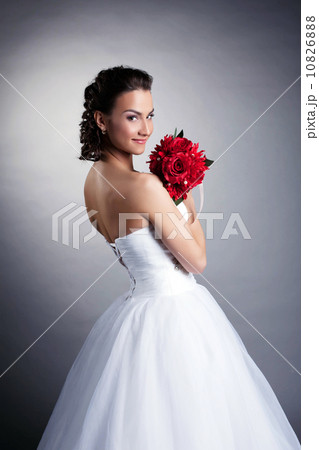 Portrait of attractive bride posing with bouquet 10826888
