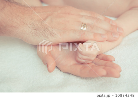 mother and father hold hand of baby mother and father hold hand of baby 10834248