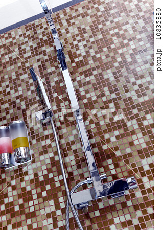 Modern designer tap and shower in bathroom Modern designer tap and shower in bathroom 10835330