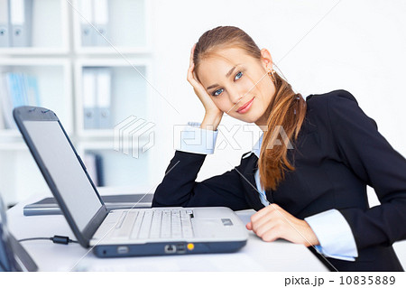 Portrait of beautiful young smiling business woman working on a Portrait of beautiful young smiling business woman working on a 10835889