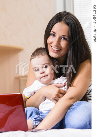 mother and son are using laptop 10841295