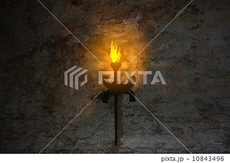 torch on the wall of an old castle 10843496