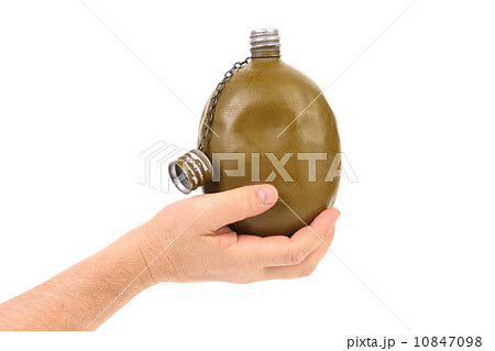 Hand holds old army canteen. Hand holds old army canteen. 10847098
