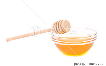 Bee honey with wooden dipper 10847727