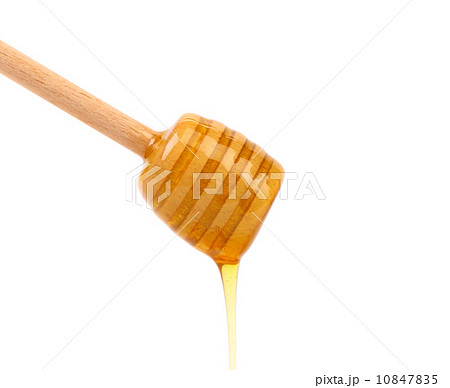 Honey dripping from a wooden dipper Honey dripping from a wooden dipper 10847835