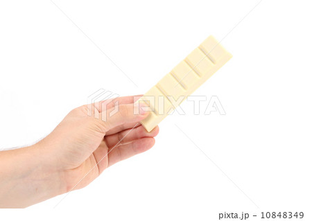 Hand holds bar of white chocolate. 10848349