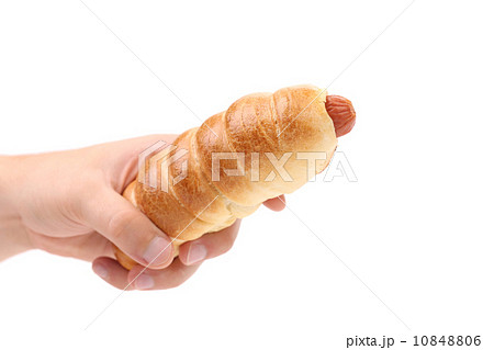Hand holds hot dog baked. 10848806