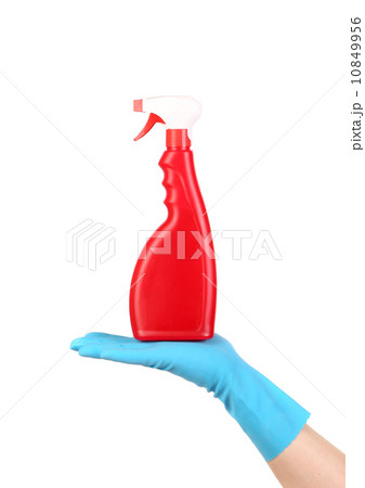 Hand in glove holding red plastic spray bottle Hand in glove holding red plastic spray bottle 10849956