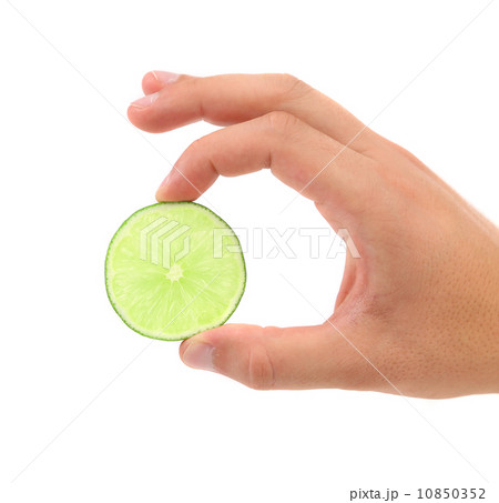 Slice Of Lime In A Hand. White Background. 10850352
