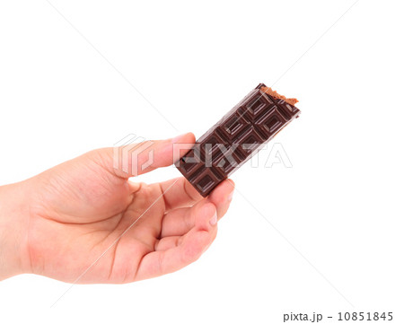 Hand holds chocolate bar with filling. 10851845