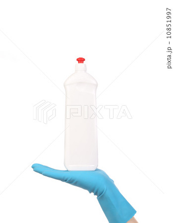 Hand in glove holding white plastic bottle 10851997