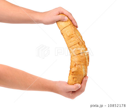 Hands holds sliced long loaf. 10852178