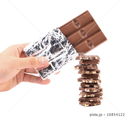 Bar of chocolate in foil and tasty morsel. 10854122